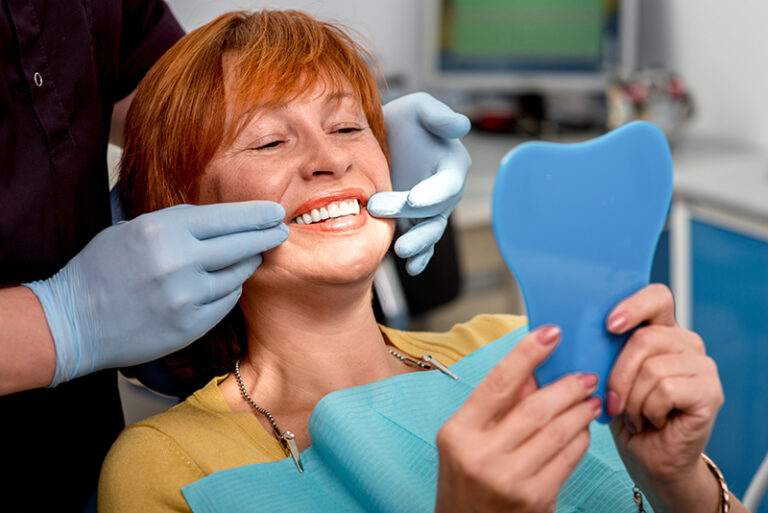 woman choosing dentures or dental implants