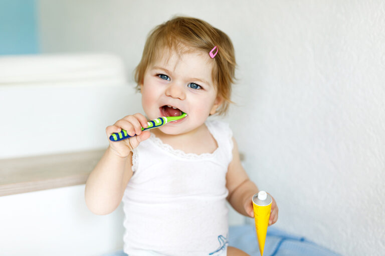 Little Baby Girl Holding Toothbrush