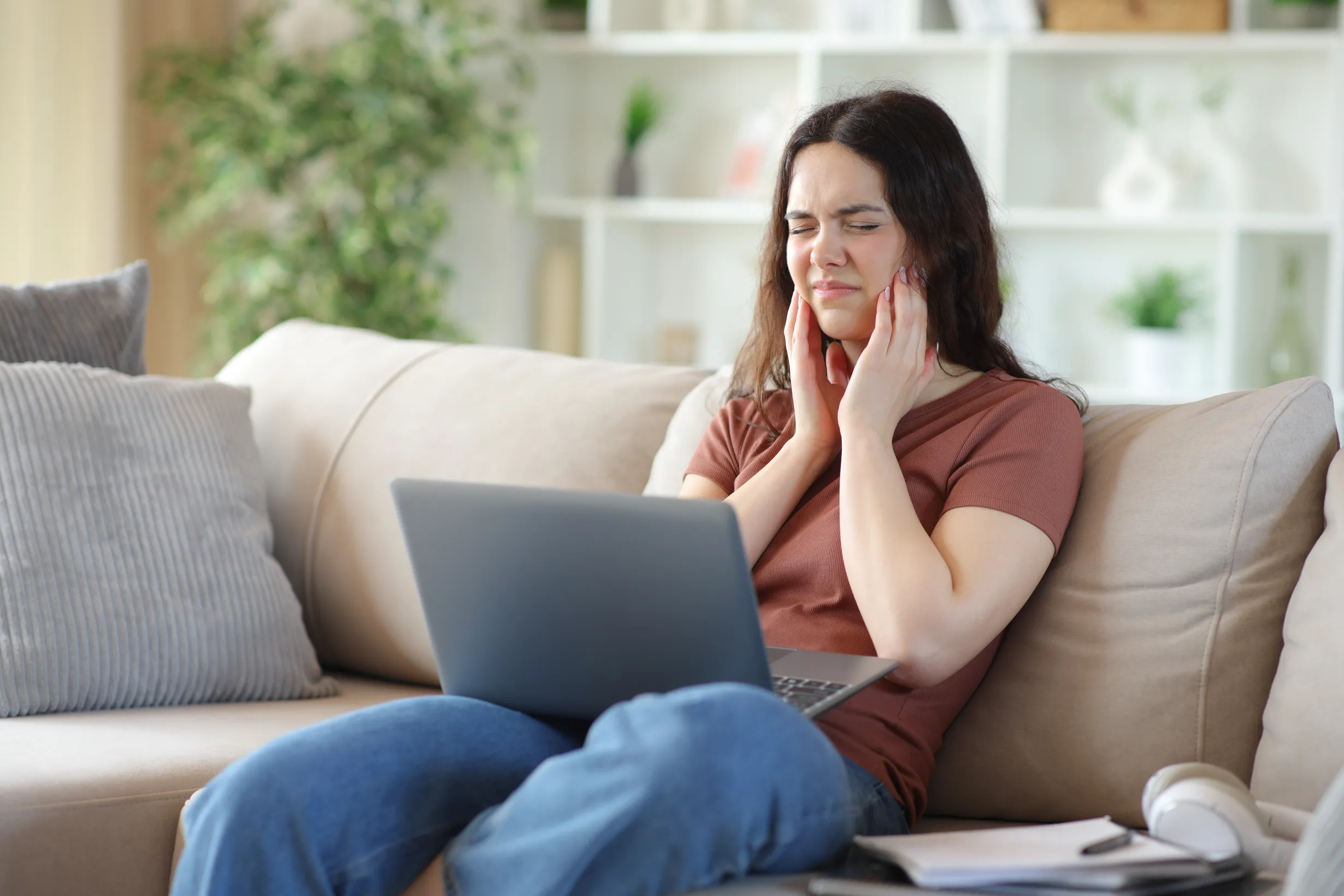 A patient experiencing jaw pain from a TMJ disorder
