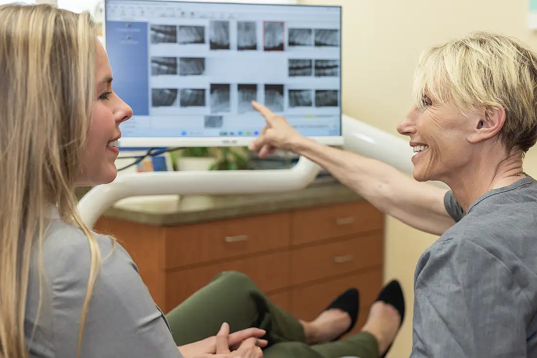 Dr. Eva Hogan reviewing digital X-rays with a patient