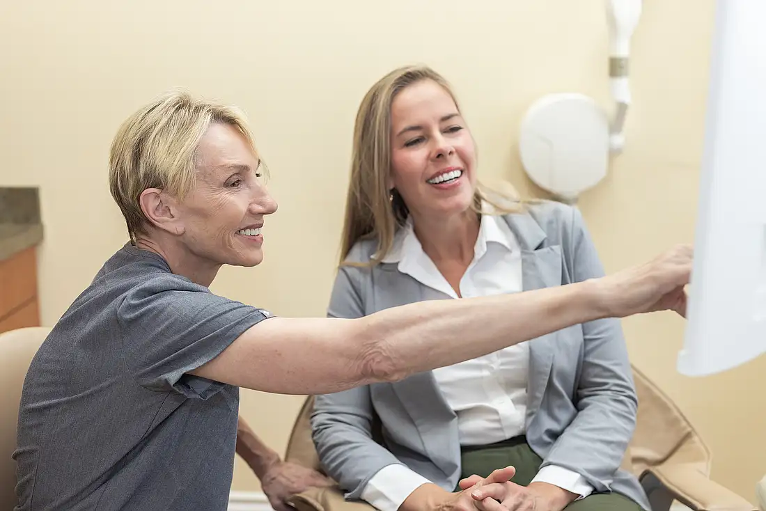 Dr. Eva Hogan talking with a patient in the dental chair