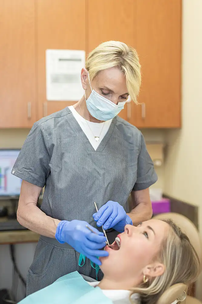 A patient receiving a gentle professional dental cleaning