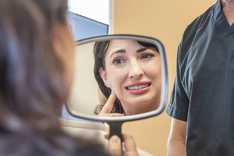 A dentist reviewing digital X-rays with a patient