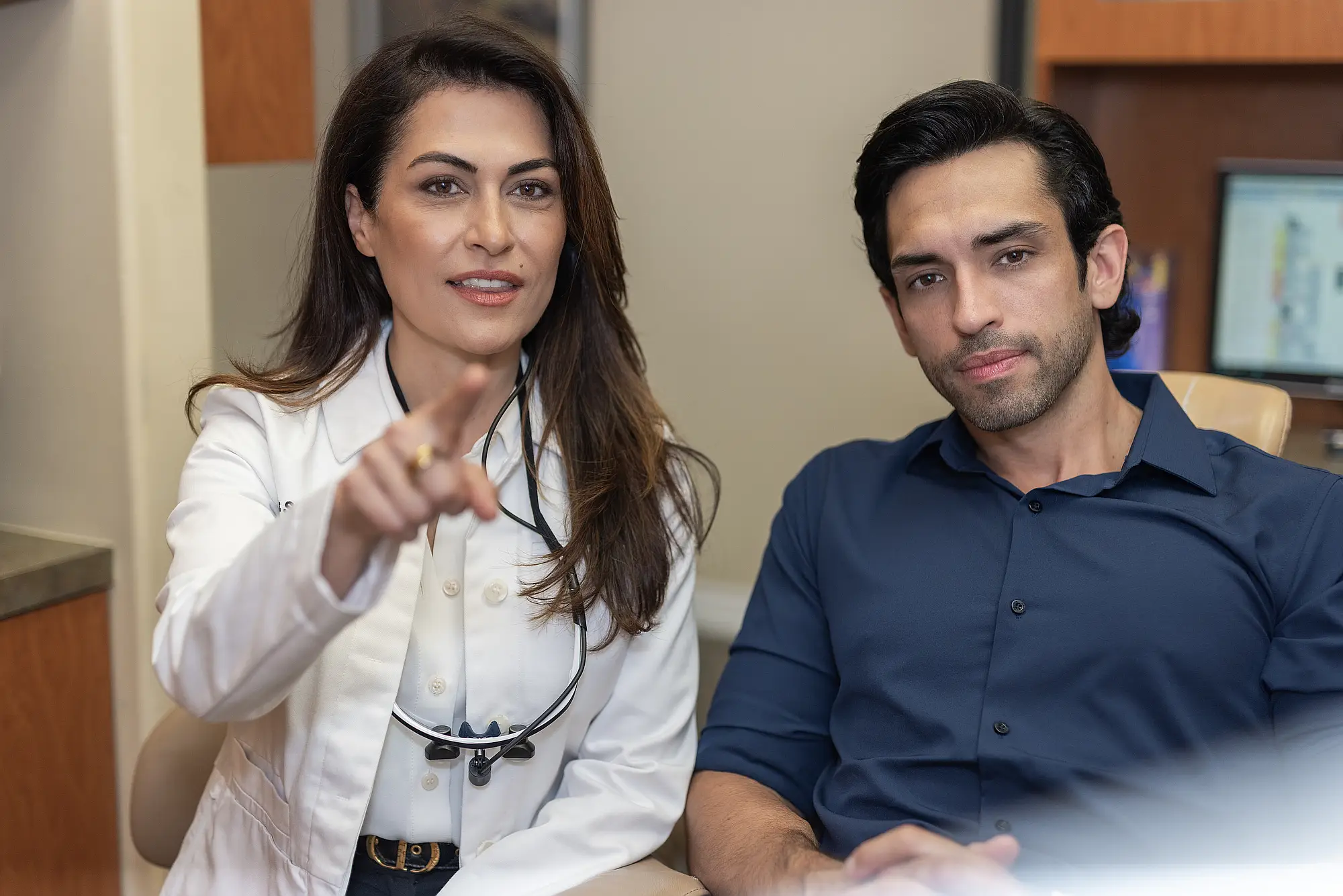 Dr. Sharareh Marhabi talking with a patient in the dental chair