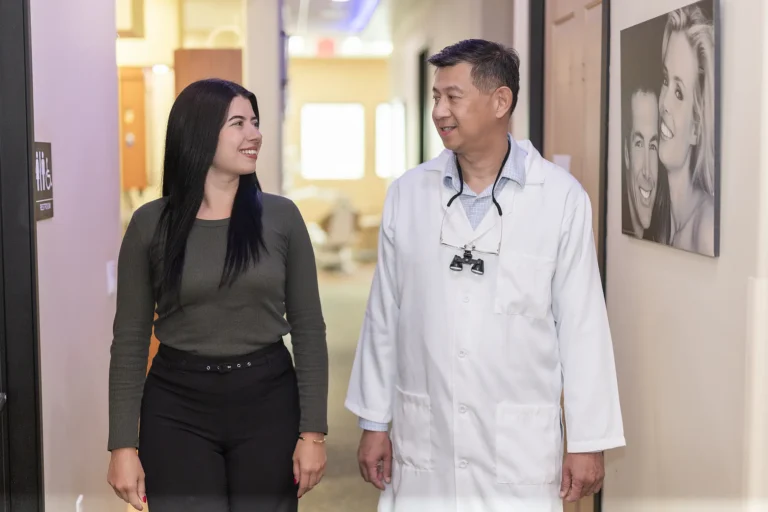 Dr. Tom Jou walking with a patient through the office