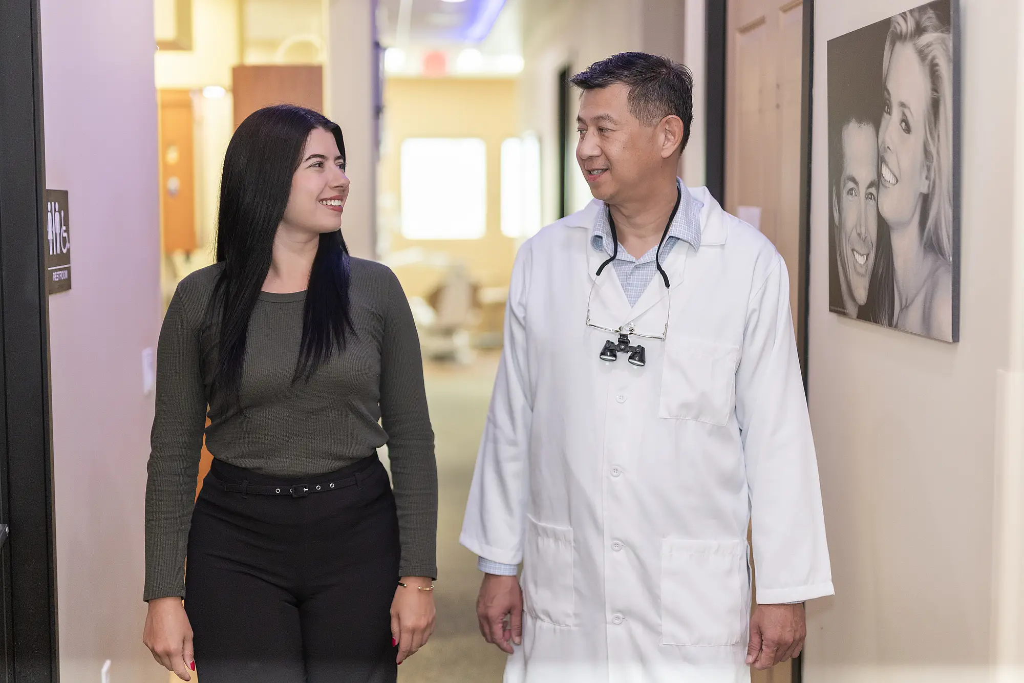 Dr. Tom Jou walking with a patient through the office